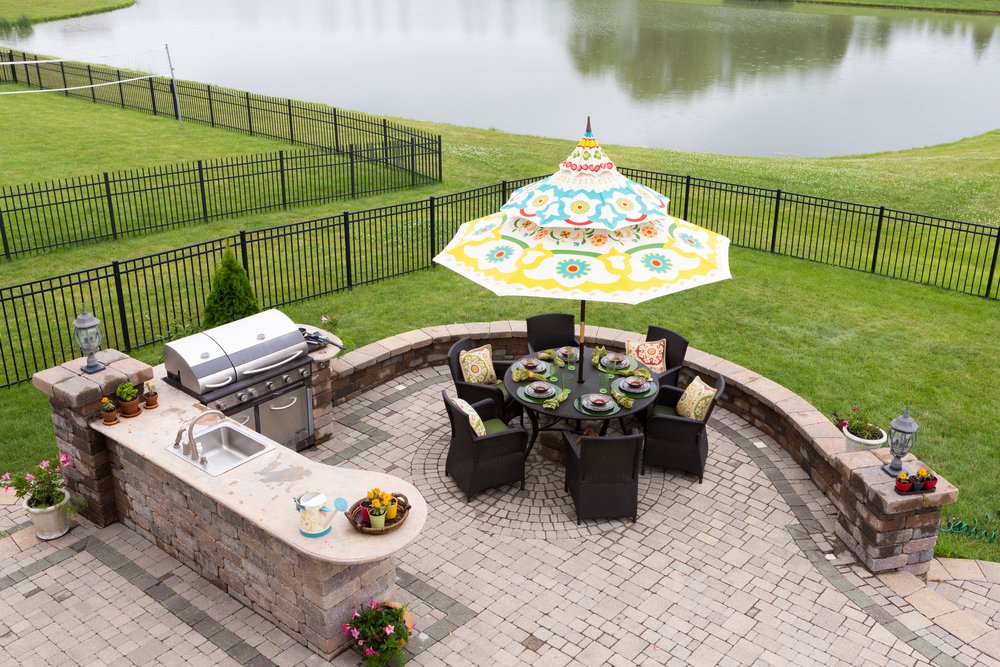 Outdoor,living,space,on,a,brick,patio,overlooking,a,tranquil